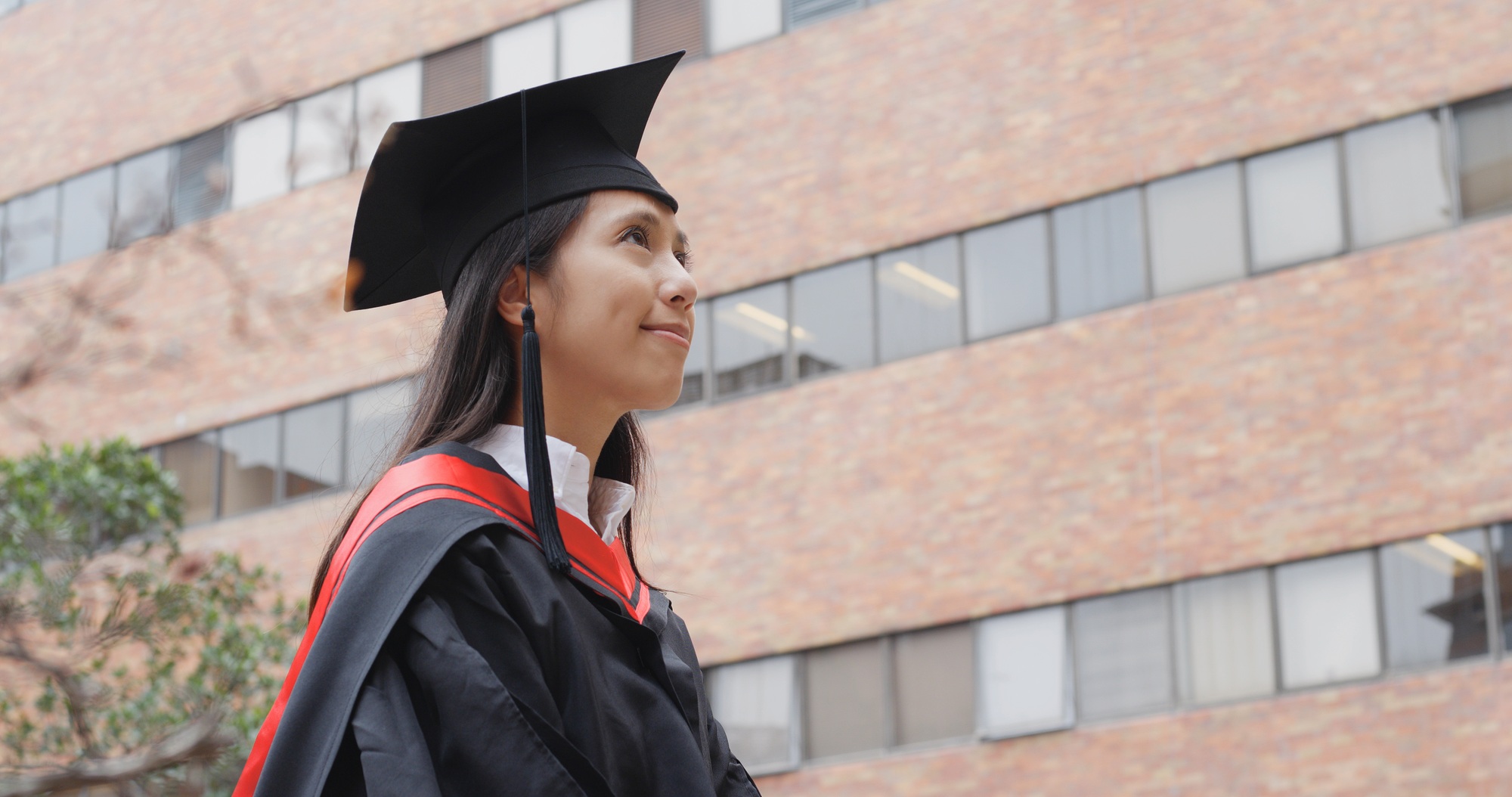 Young asian woman look at top in university campus